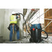 Bosch VAC140AH HEPA dust extractor connected to a concrete grinding tool on a commercial jobsite