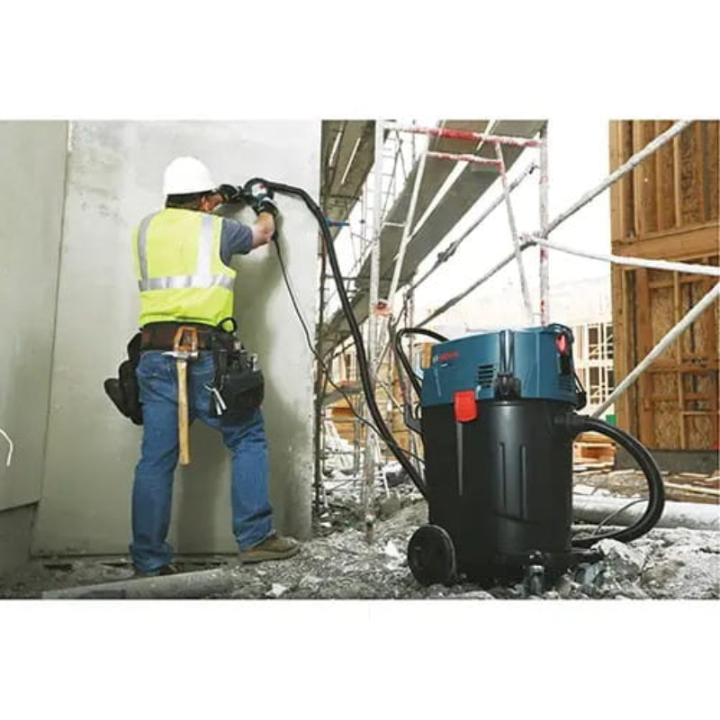Bosch VAC140AH HEPA dust extractor connected to a concrete grinding tool on a commercial jobsite