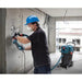 Contractor using the Bosch VAC140AH HEPA dust extractor for indoor dust collection during renovation