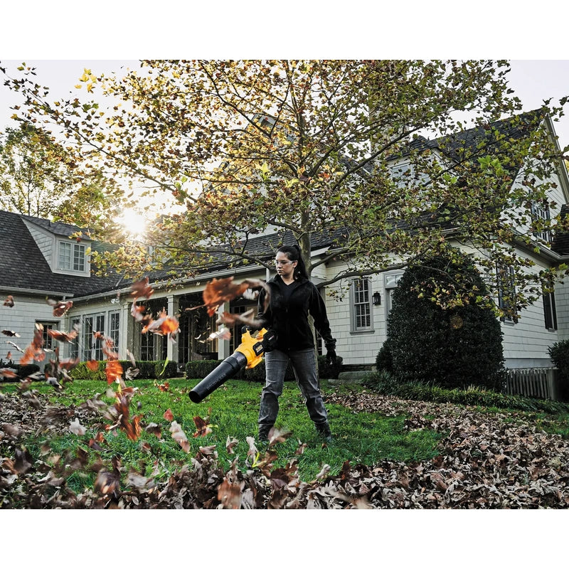 DEWALT DCBL772B FLEXVOLT blower clearing autumn leaves outdoors