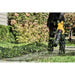 DEWALT DCBL772B cordless blower clearing grass from a walkway