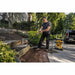 DEWALT electric pressure washer being used to clean a stone patio and outdoor surfaces