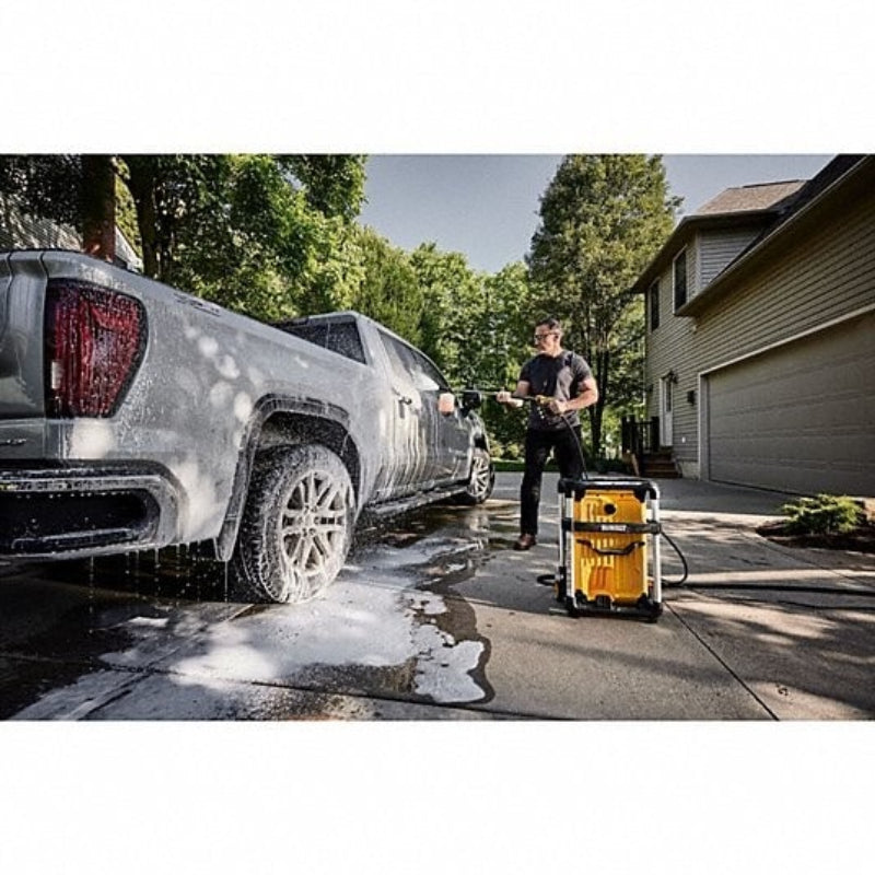 DEWALT 15 Amp electric pressure washer cleaning an SUV driveway and exterior surfaces