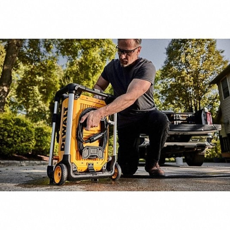 User transporting DEWALT brushless electric pressure washer with portable wheeled design