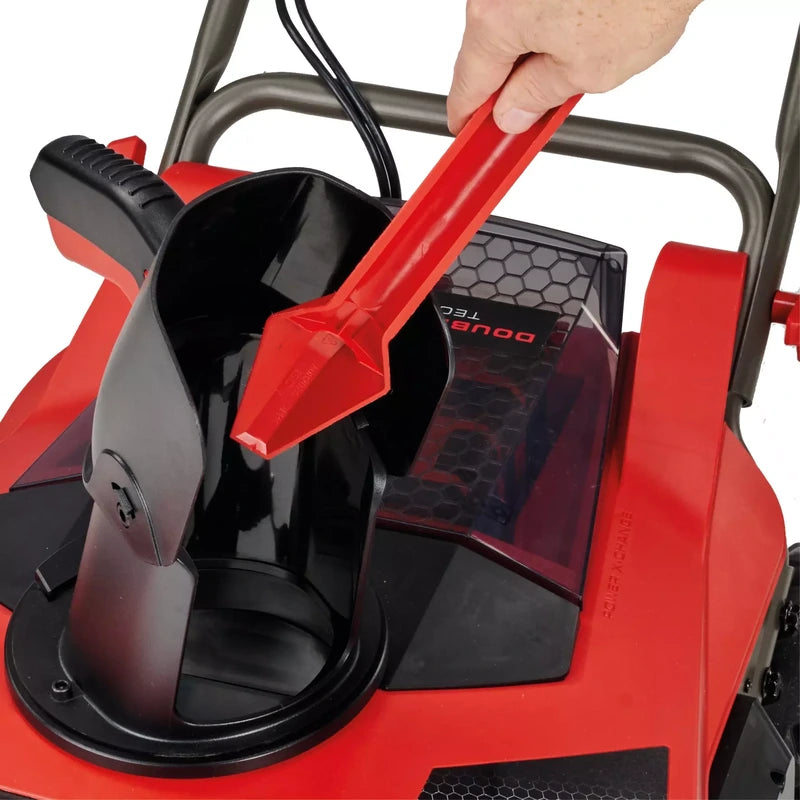 Hand adjusting the upper discharge chute on the Einhell snowblower
