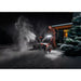 Einhell snowblower clearing snow outdoors at night