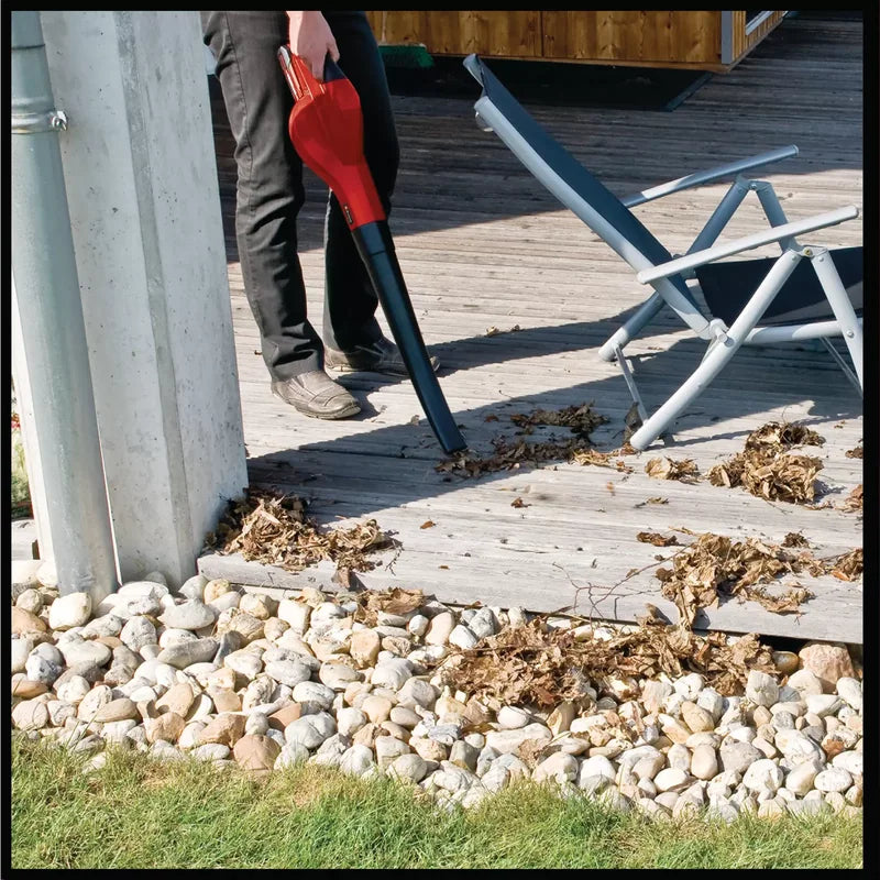Operator using Einhell 3433543 cordless leaf blower to clear deck leaves