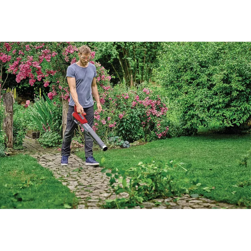 Operator using Einhell 3433556 cordless leaf blower on garden path, battery sold separately