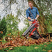 Operator using the Einhell VENTURRO cordless leaf vacuum outdoors