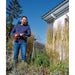 Person using the Einhell HYPRESSO pressure washer to water garden plants