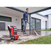 Operator using Einhell HYPRESSO 36/105 on an outdoor patio; operating setup is illustrative and batteries are sold separately