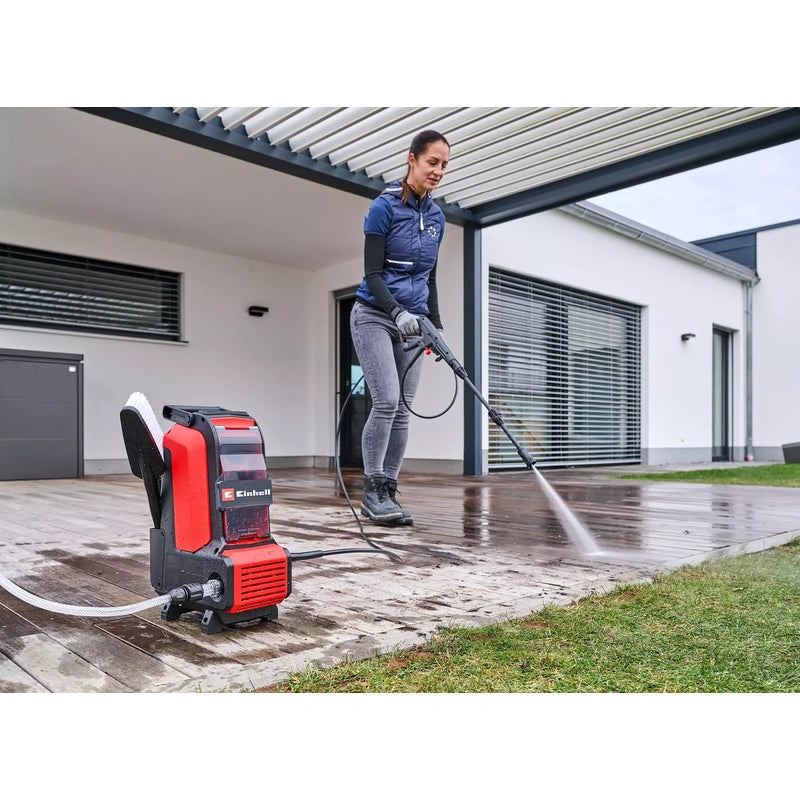 Operator using Einhell HYPRESSO 36/105 on an outdoor patio; operating setup is illustrative and batteries are sold separately