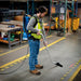 Operator using HEPA backpack vacuum with ergonomic harness