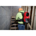 Worker wearing a Milwaukee 0895-20 backpack vacuum while cleaning a wooden staircase