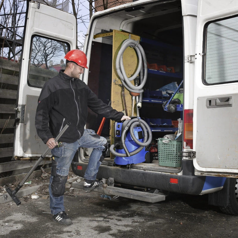 Nilfisk AERO 26 portable commercial vacuum used by a mobile service technician